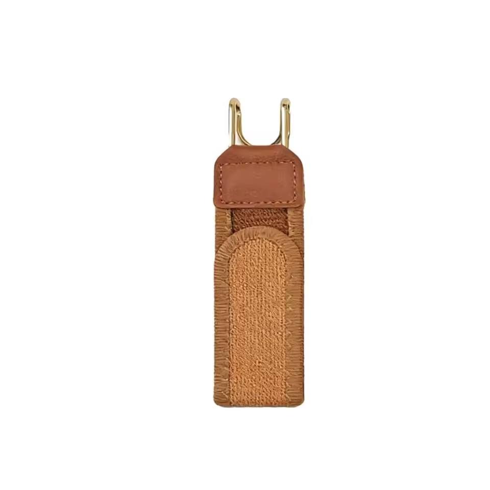 Brown textured pouch with gold clip on a white background